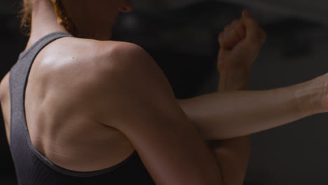 Close-Up-Studio-Shot-Showing-Mature-Woman-Wearing-Gym-Fitness-Clothing-Doing-Stretching-Exercises-1